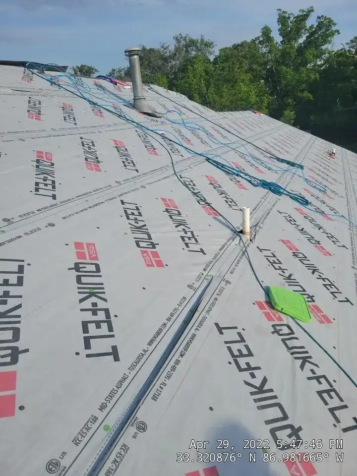 A roof with a blue tarp on it.